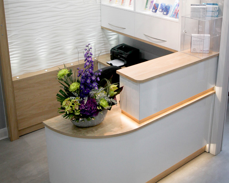 Colourful curved counter with display feature wall.